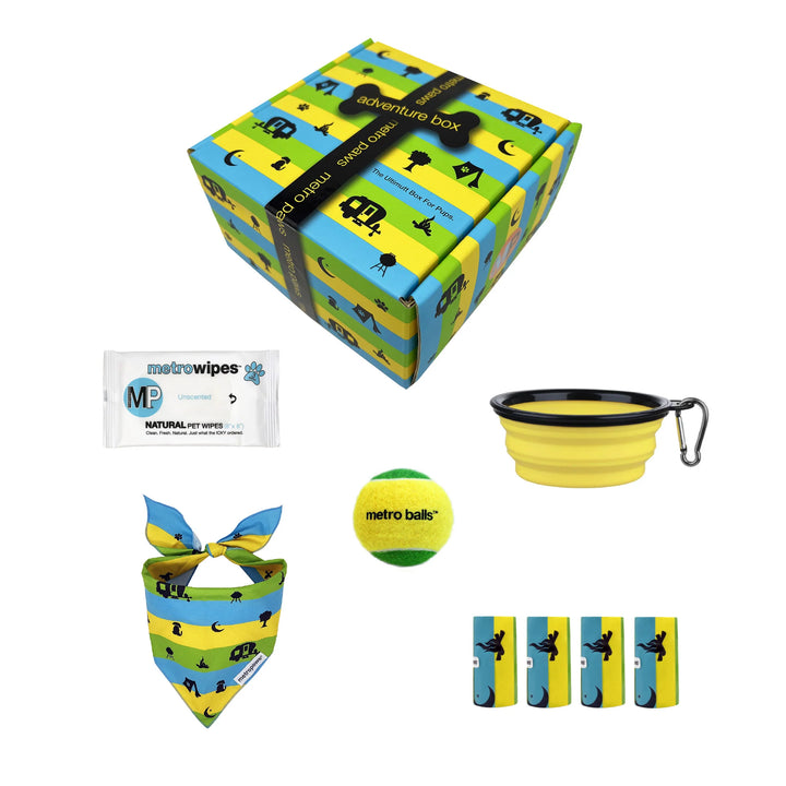 Collection of pet products including a box, bandana, ball, and wipes on a white background