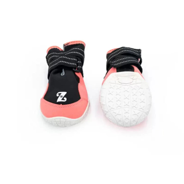 Pair of pink and black dog boots with white tread and a blue dot on sole