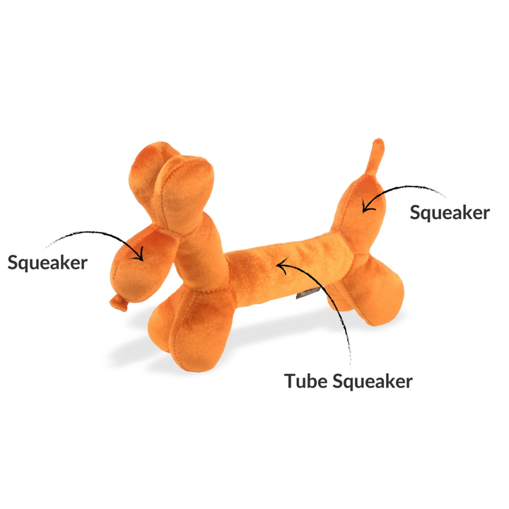 Orange dog toy shaped like a bone with labeled squeaker and tube squeaker components on a white background.