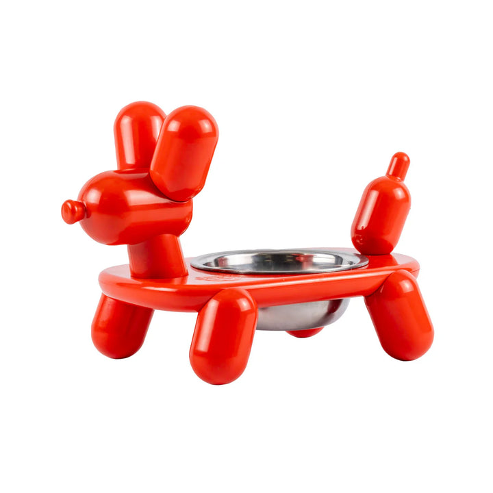 Red balloon dog-shaped pet feeder on a white background