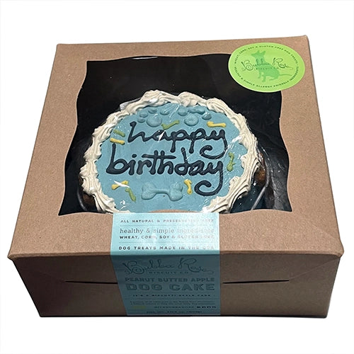 Dog birthday cake in a box with a visible brand label on a white background