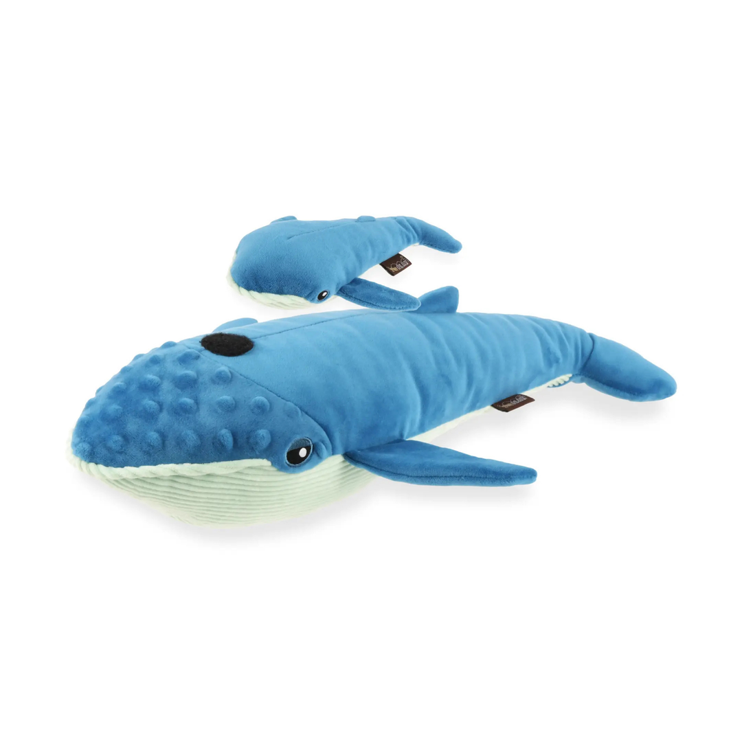 Blue plush whale toy with textured belly on a white background