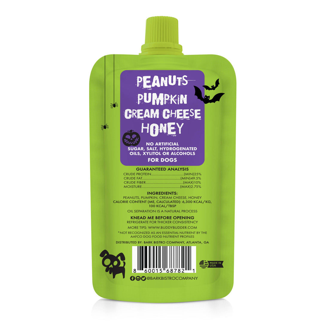 A green squeeze pouch of Bark & Biscuit Company 'Peanuts Pumpkin Cream Cheese Honey' dog treat, featuring a purple label with white text and black spider graphics.