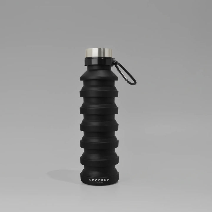 Black collapsible water bottle with carabiner on a gray background