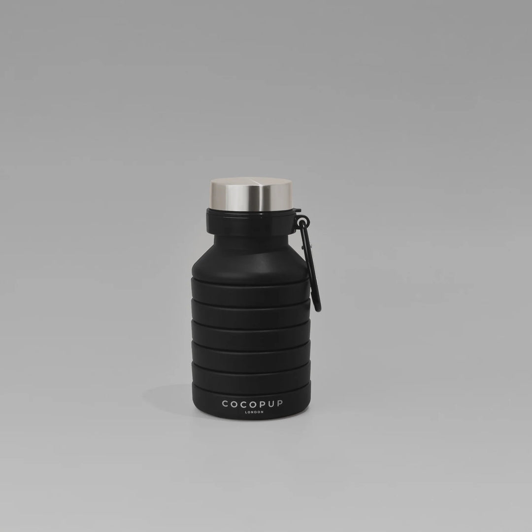 Black water bottle with silver cap on a gray background