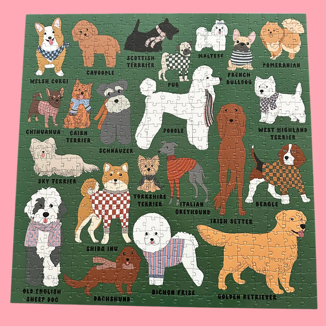 Puzzle with illustrations of various dog breeds on a green background