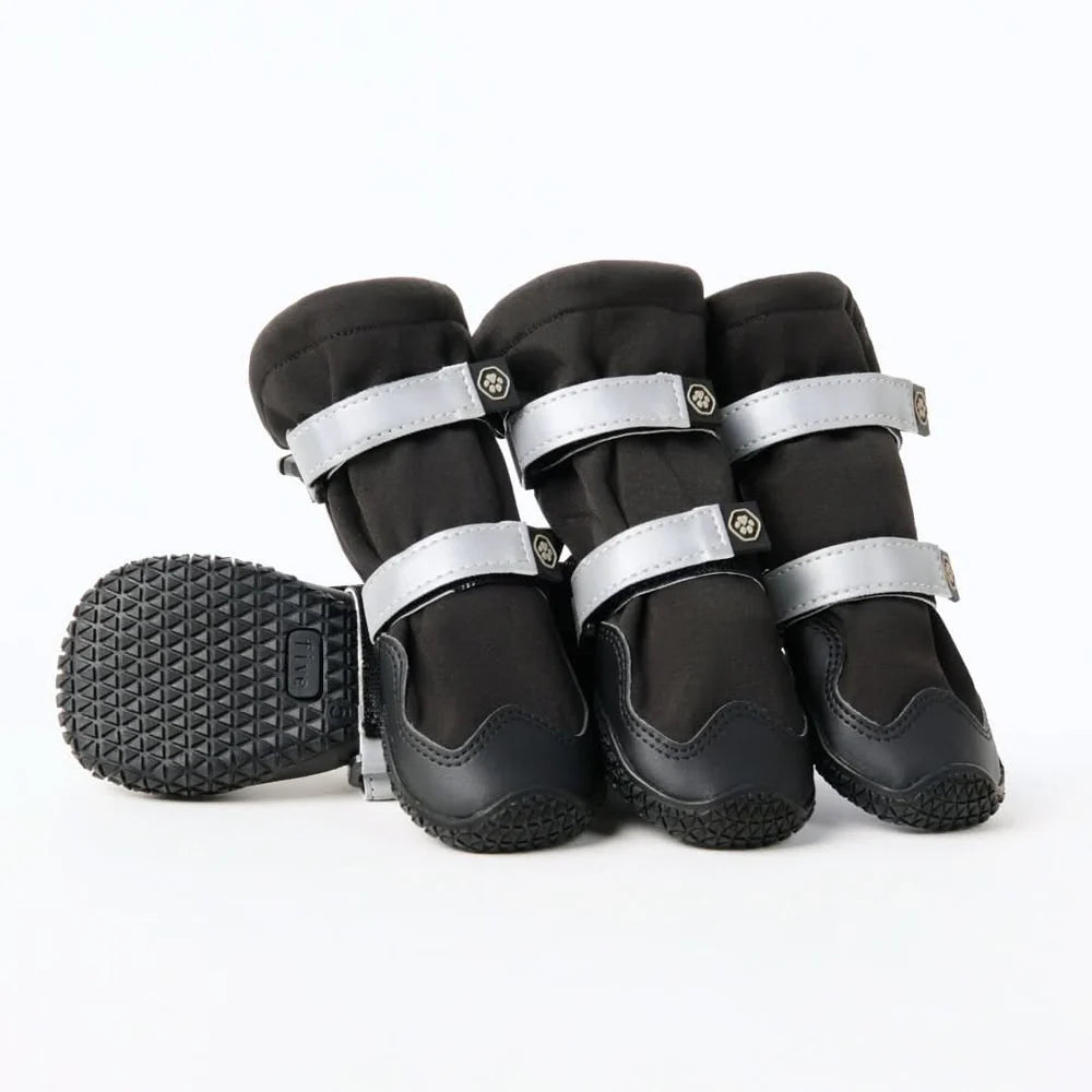 Set of black dog flex shell boots with silver straps on a white background