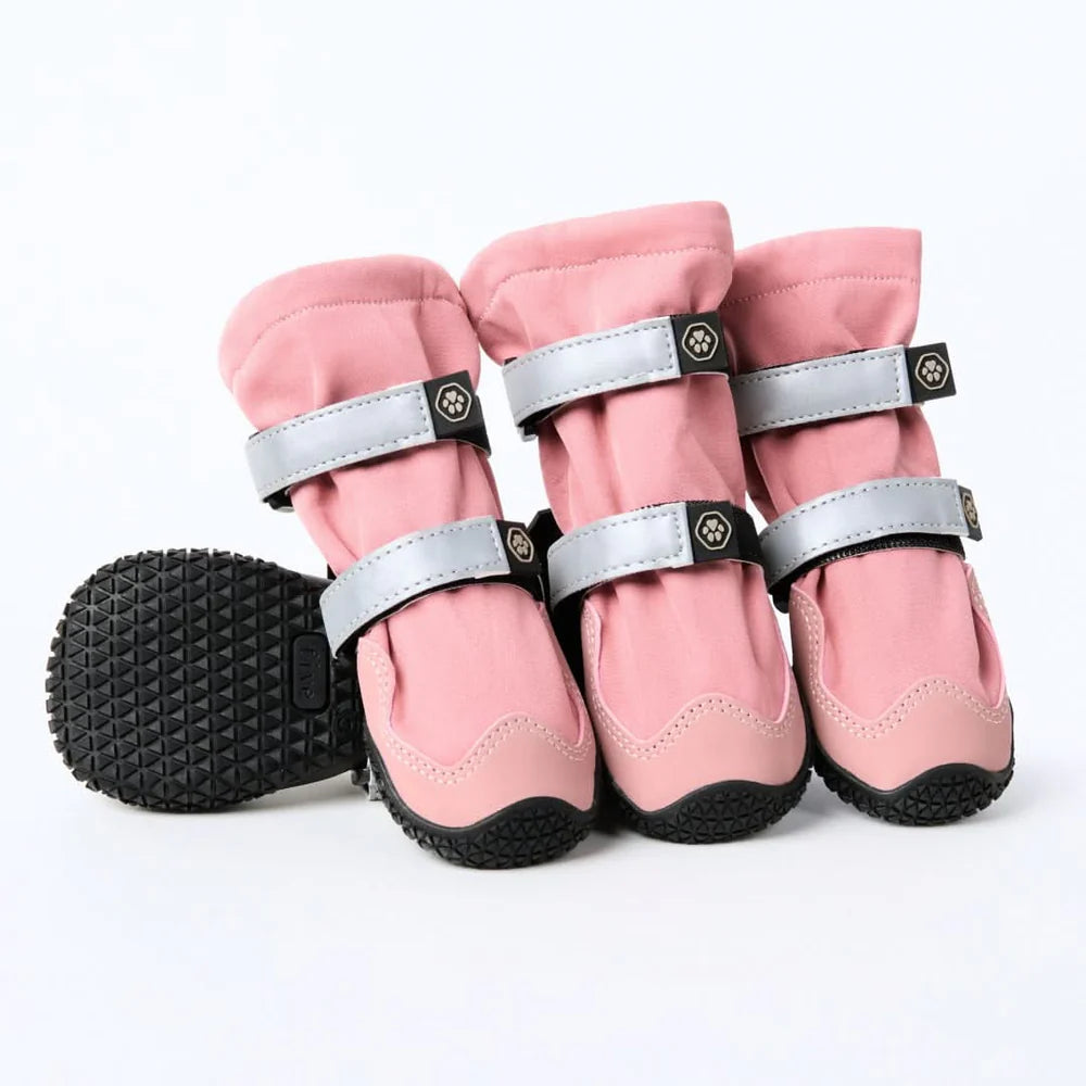 Set of pink flex shell dog boots with black soles on a white background