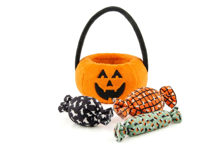 Orange jack-o’-lantern dog toy basket displayed with three removable plush candy toys for Halloween play.