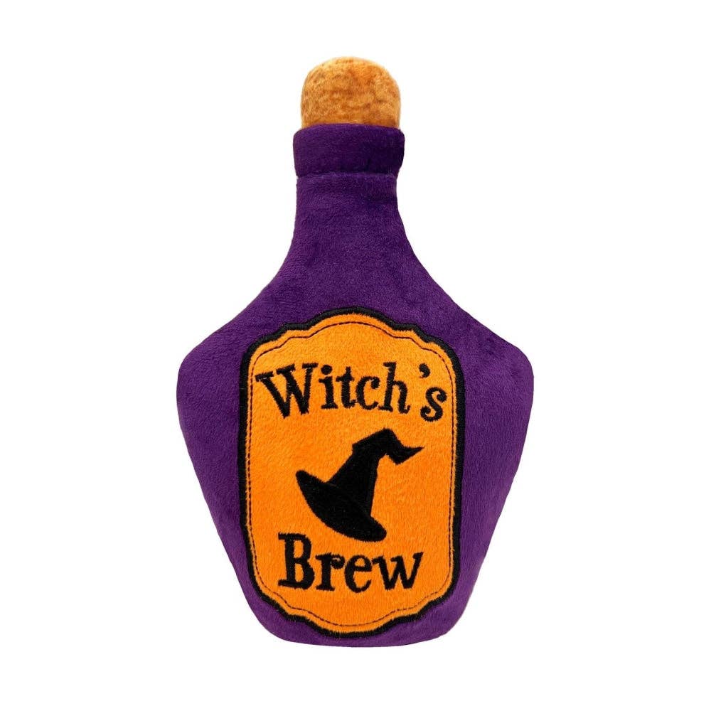 Front view of the Huxley & Kent Witch’s Brew Halloween dog toy in purple with an orange label and black witch hat graphic.