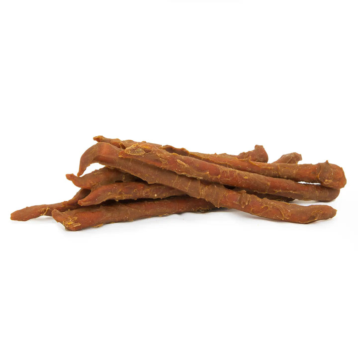 Stack of dried dog treats on a white background