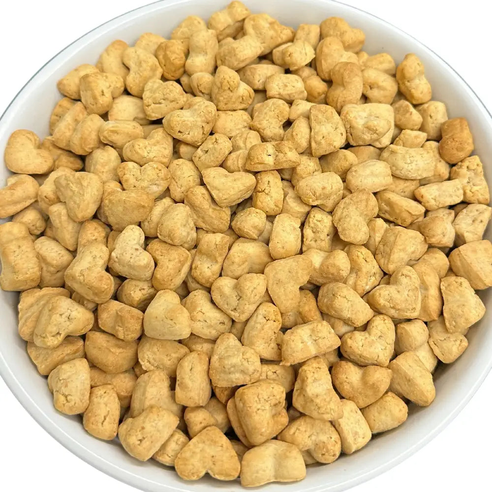 Heart-shaped dog treats in a white bowl