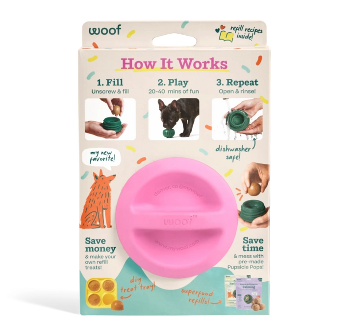 A pink plastic dog toy presented in its retail packaging against a white background. The packaging features the brand name 'woof' and an 'How It Works' diagram explaining how the toy works.