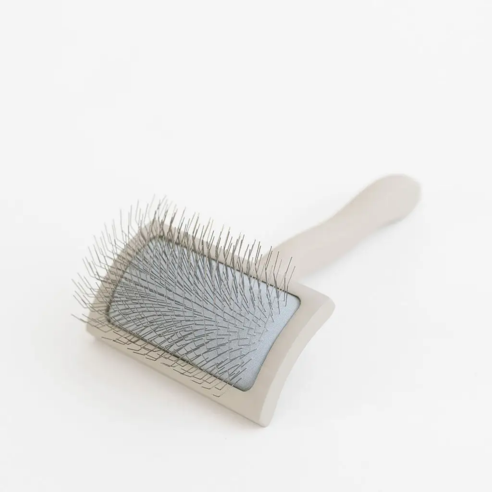 Pet grooming brush with clear plastic guard on a white background