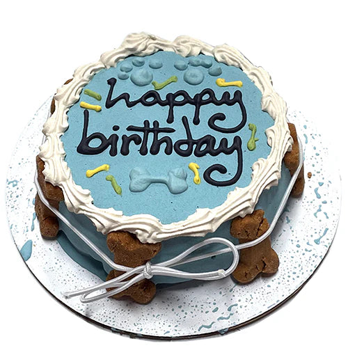 Dog birthday cake with 'Happy Birthday' text on a blue background