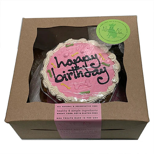 Pink birthday cake with 'happy birthday' text in a brown box packaging.