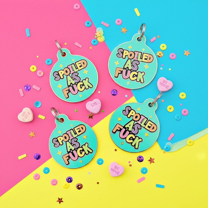 Four round turquoise tags with 'Spoiled as Fuck' text on a colorful background