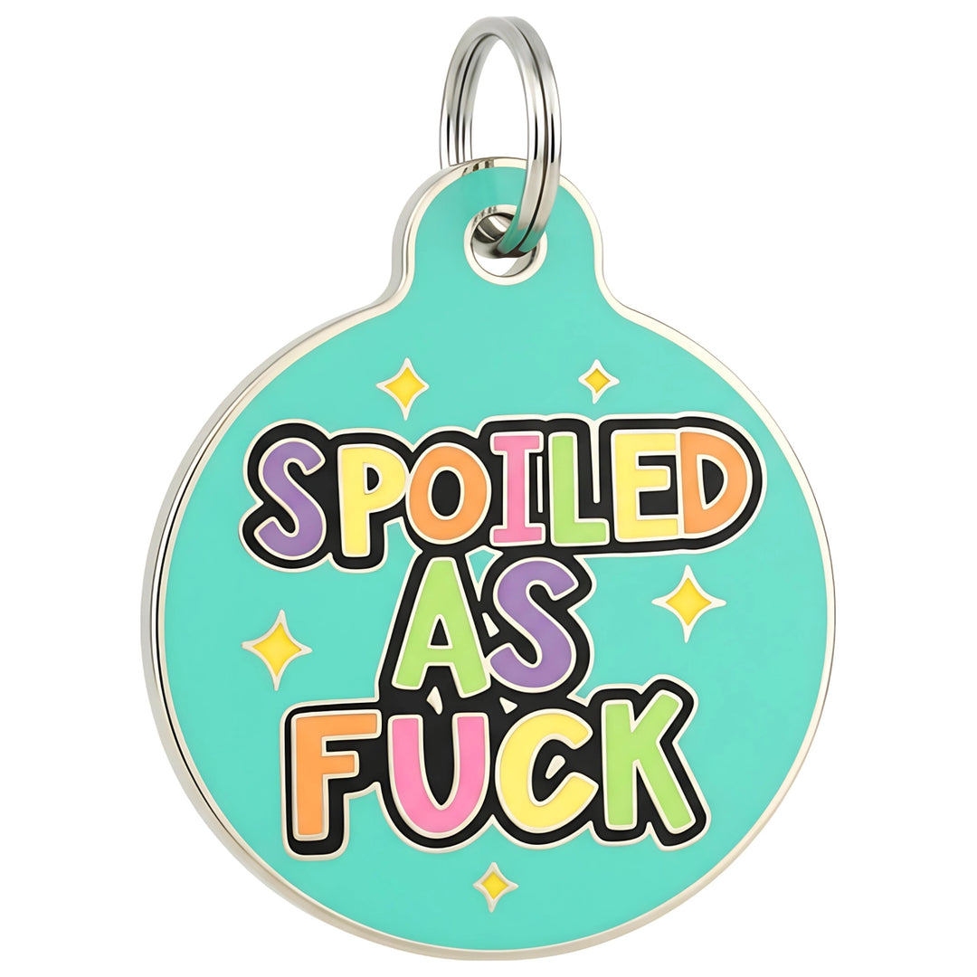 Round turquoise pet tag with colorful text 'SPOILED AS FUCK' on a white background