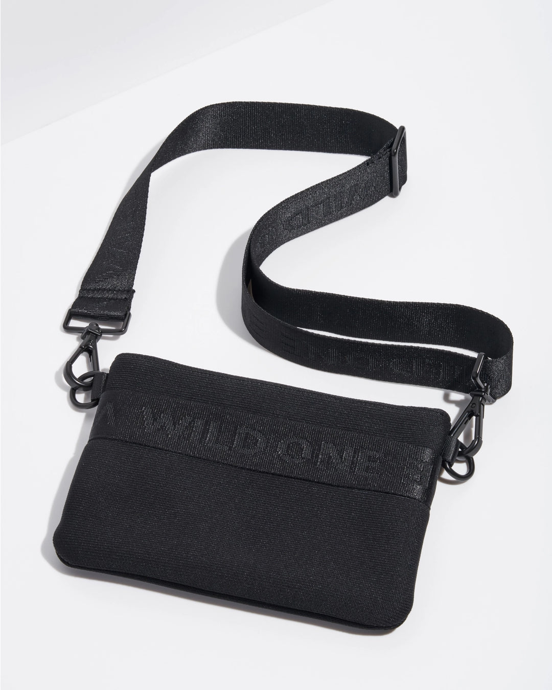 Black crossbody bag with 'WILD ONE' text on a white background