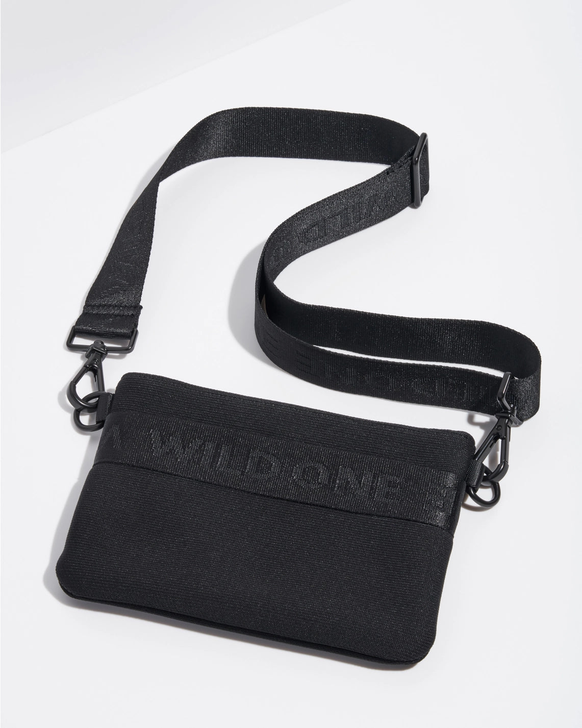Black crossbody bag with 'WILD ONE' text on a white background