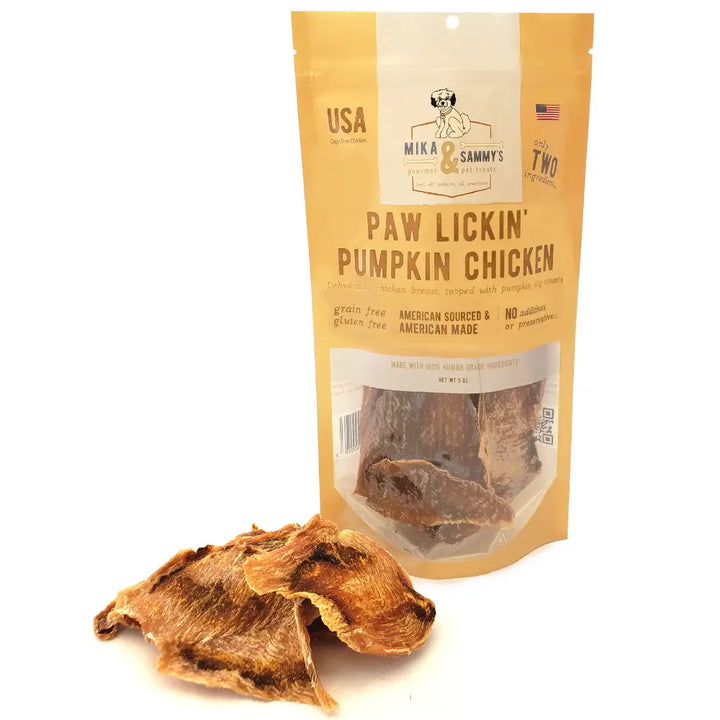 Package of Mika & Sammy's Paw Lickin' Pumpkin Chicken dog treat with a single treat in front on a white background